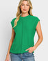 Woman wearing a green sleeveless top against a white background