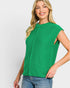 Woman wearing a green sleeveless top against a white background