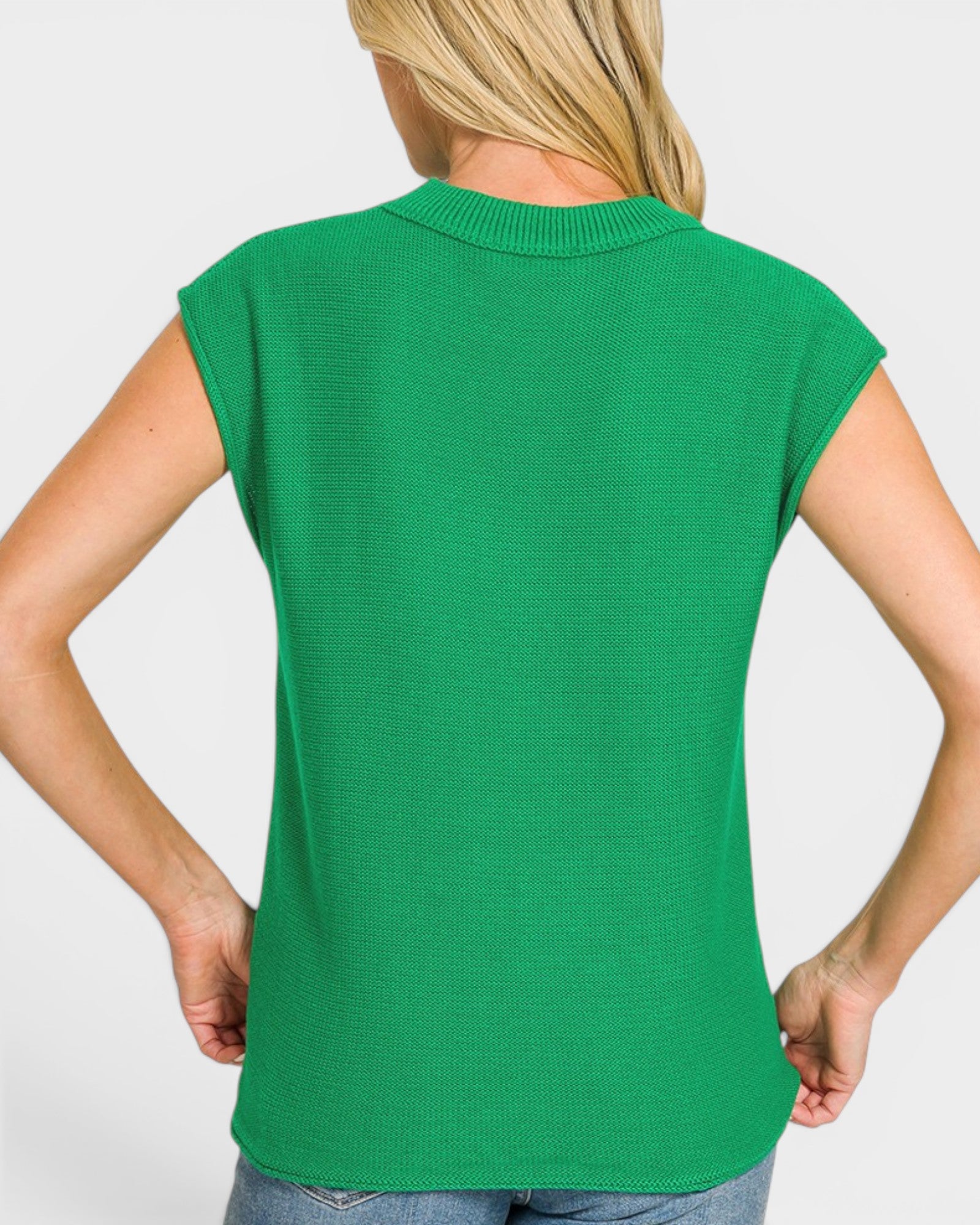 Green sleeveless top worn by a person on a white background
