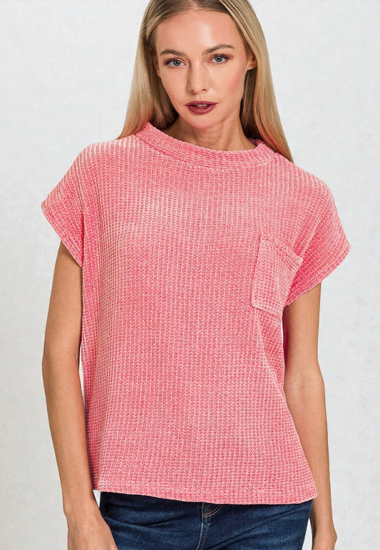 Woman wearing a pink textured t-shirt against a white background