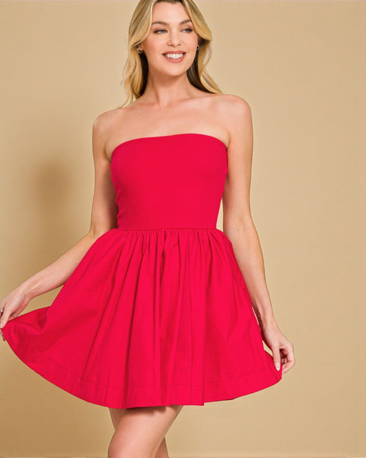 Woman wearing a strapless red dress against a beige background