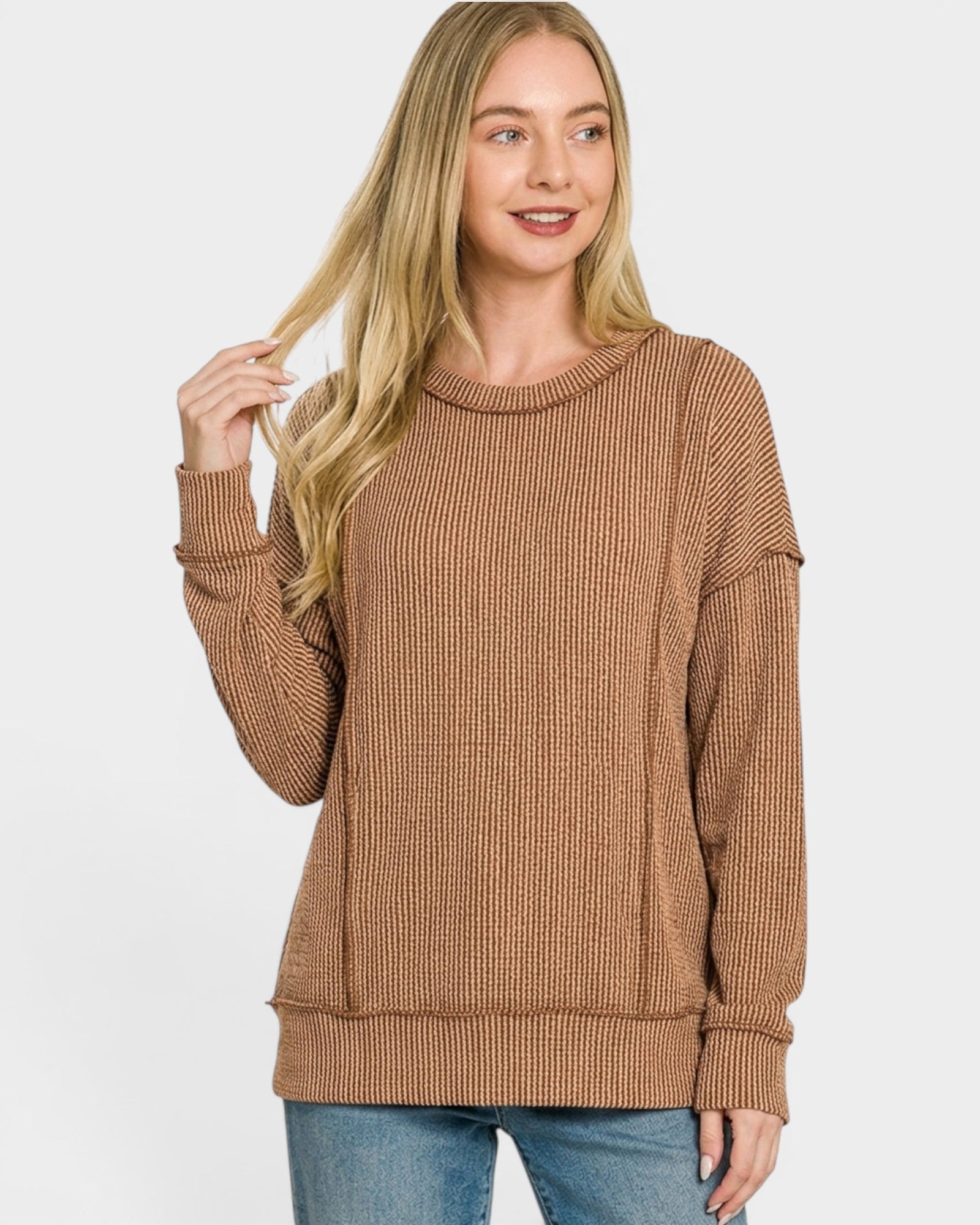 Woman wearing a brown sweater on a white background