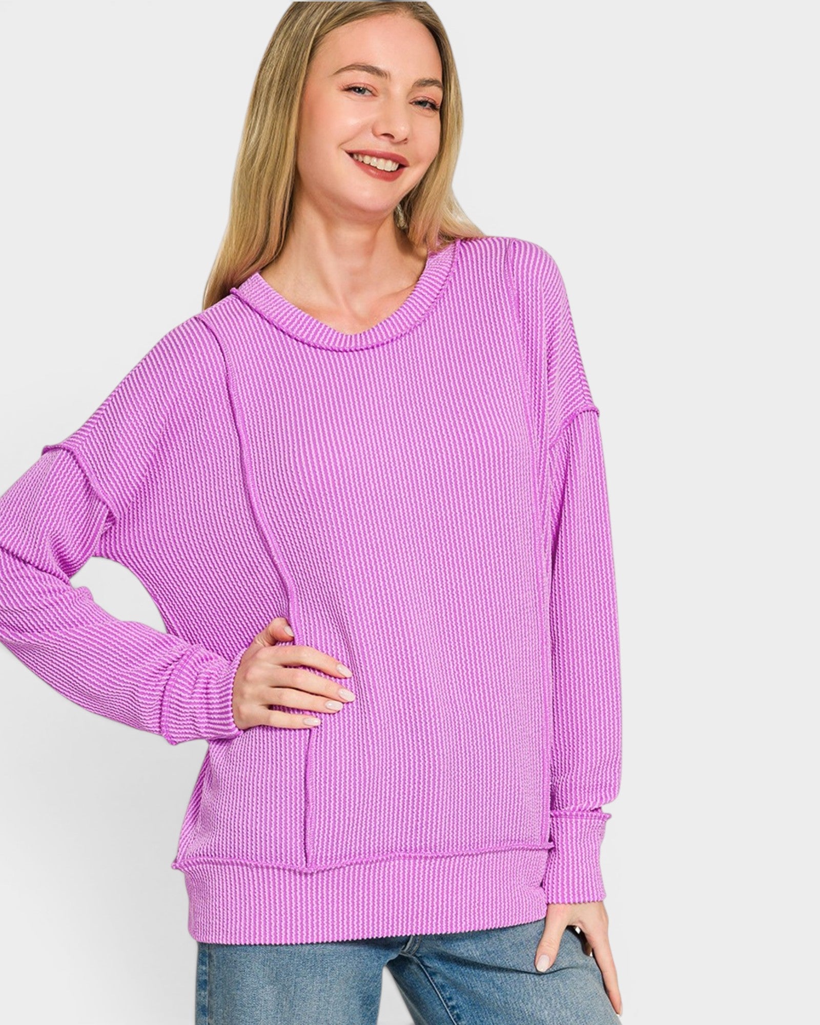 Woman wearing a purple sweater on a plain background