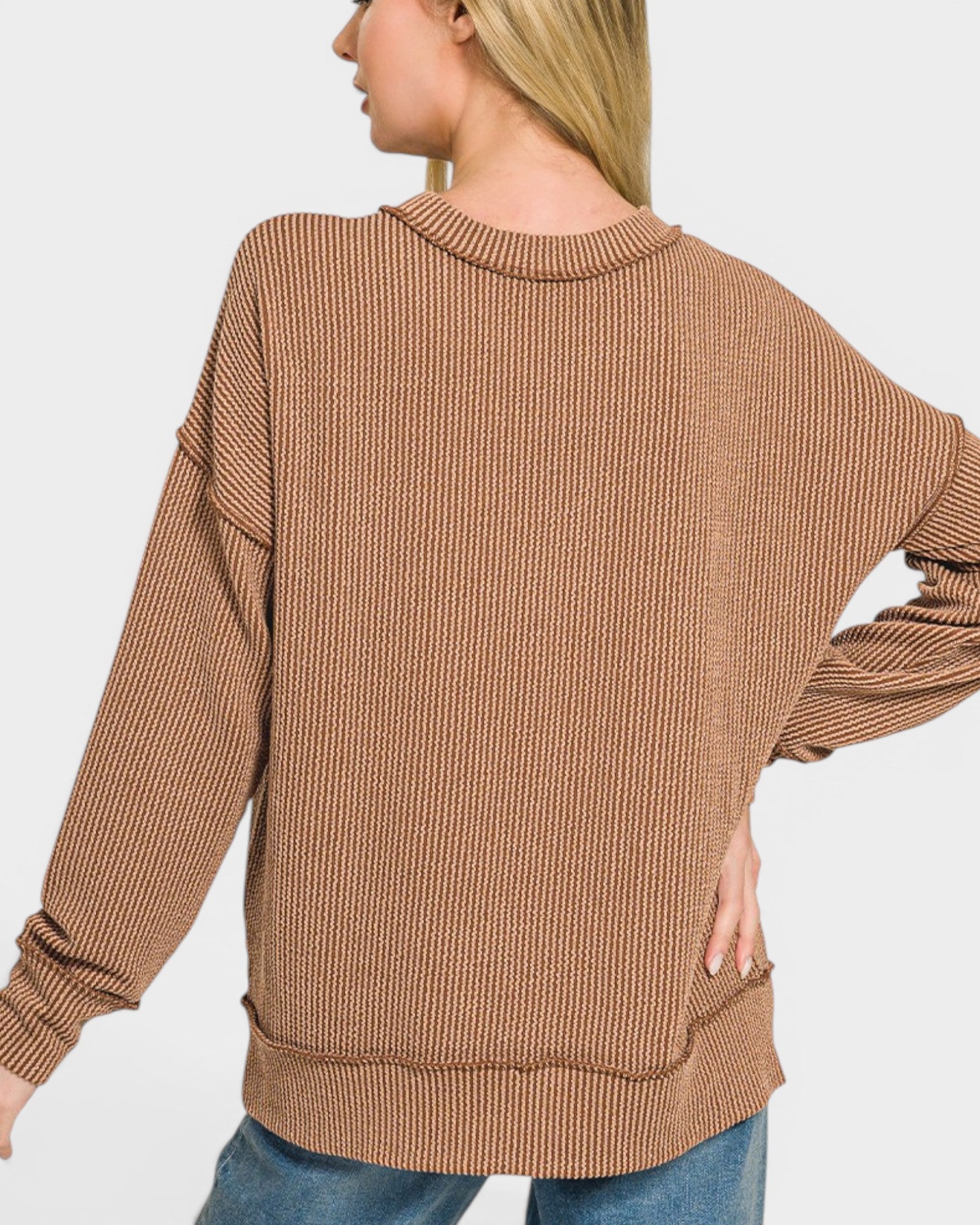 Woman wearing a brown ribbed sweater on a white background