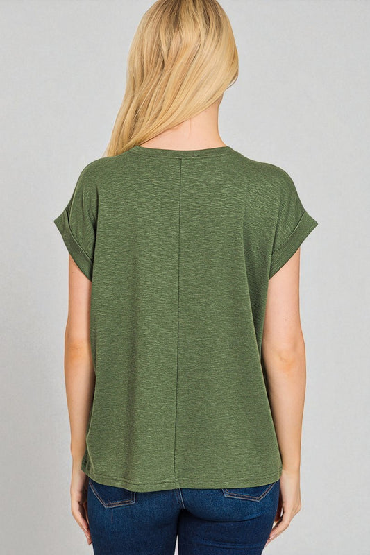 Person wearing a green t-shirt on a gray background