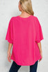 Person wearing a bright pink oversized t-shirt against a light gray background