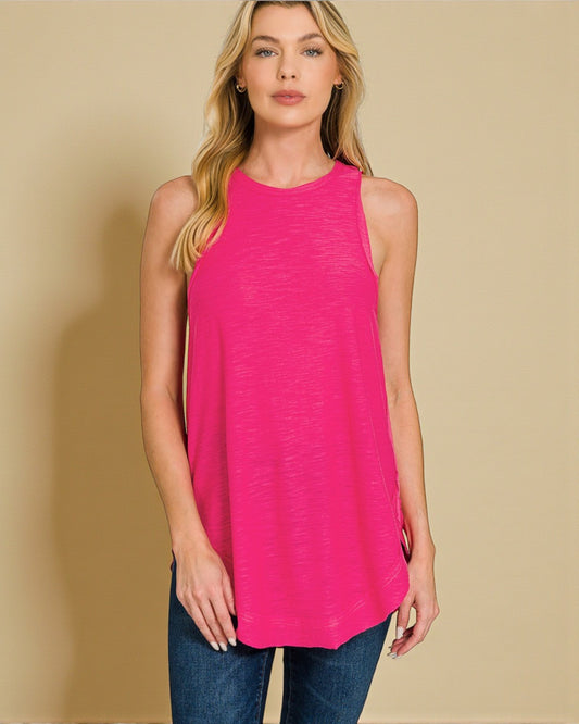 Woman wearing a bright pink sleeveless top against a beige background