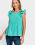 Woman wearing a turquoise top with ruffled sleeves on a white background