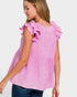 Woman wearing a pink ruffled blouse against a white background