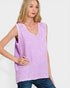 Woman wearing a purple checkered sleeveless top against a white background