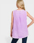 Woman wearing a sleeveless purple checkered top on a white background