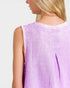 Person wearing a light purple sleeveless top on a plain background