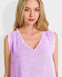 Woman wearing a light purple sleeveless top against a white background