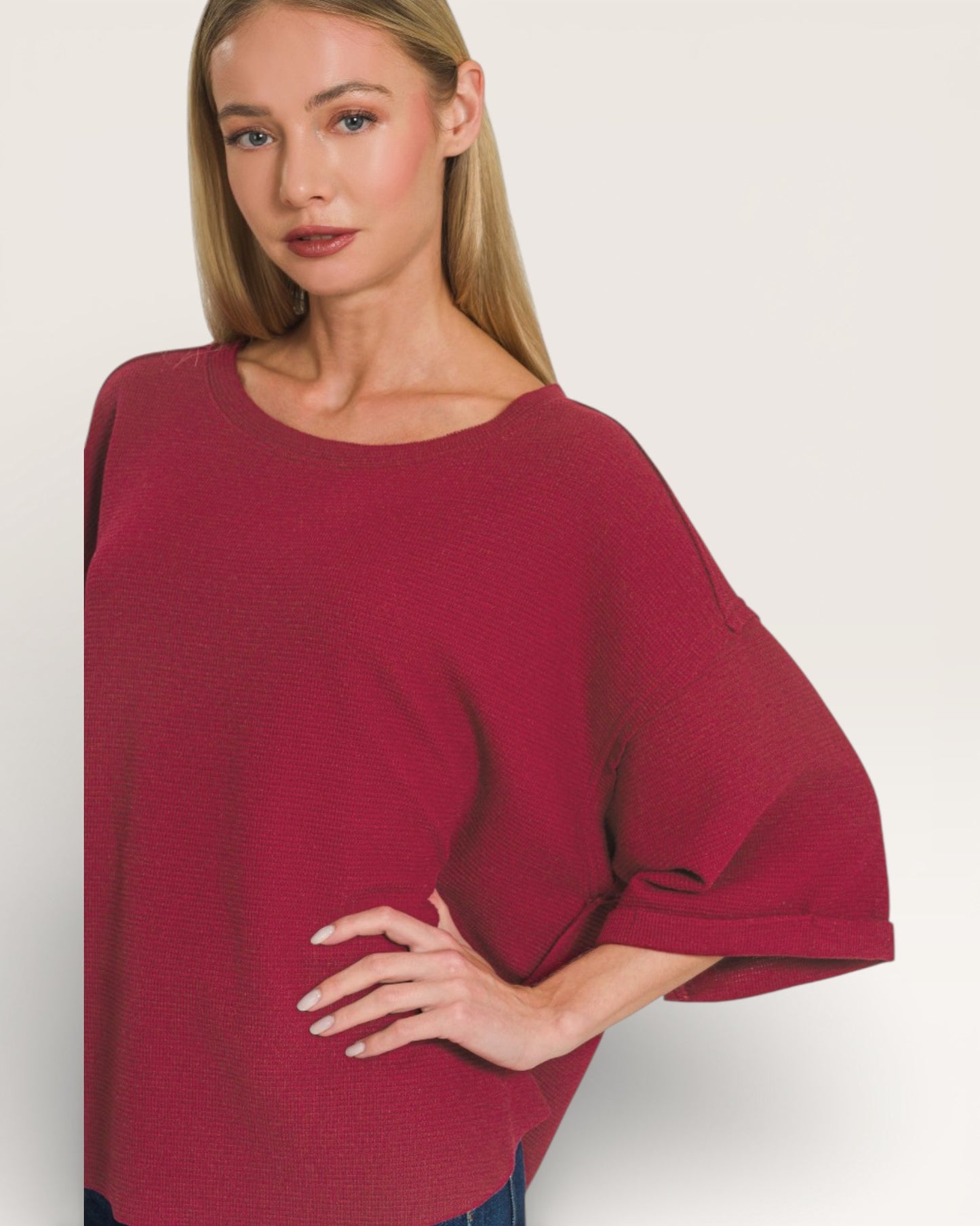 Woman wearing a burgundy oversized shirt on a white background