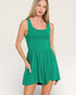 Woman wearing a green dress against a plain background