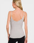 Woman wearing a gray tank top against a plain background