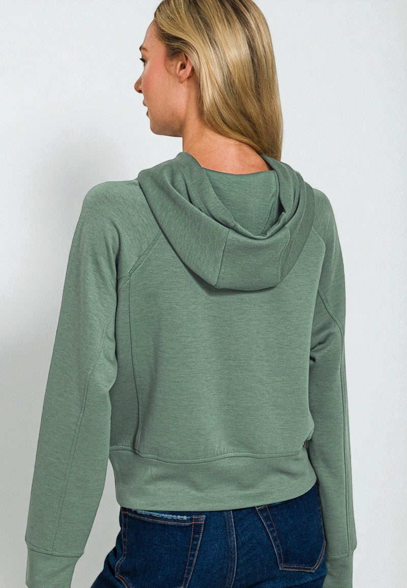 Person wearing a green hoodie from behind on a white background