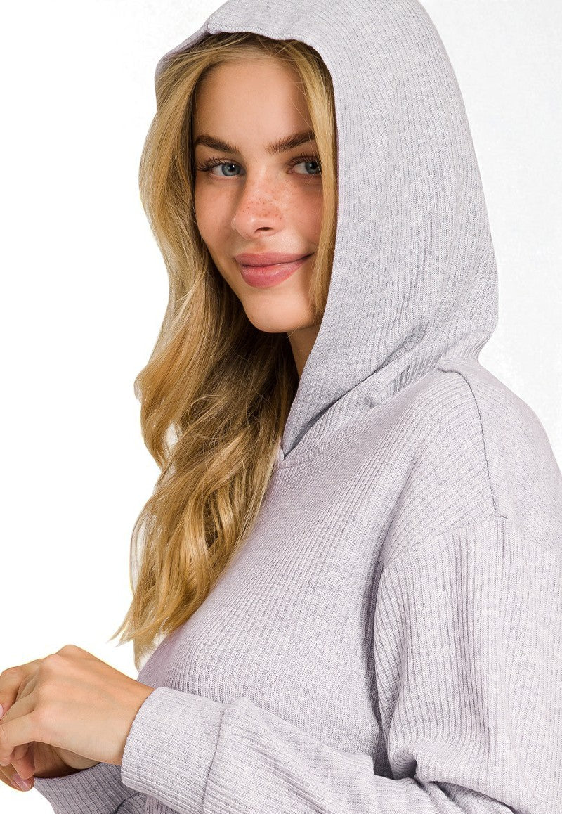 Woman wearing a gray hoodie on a white background