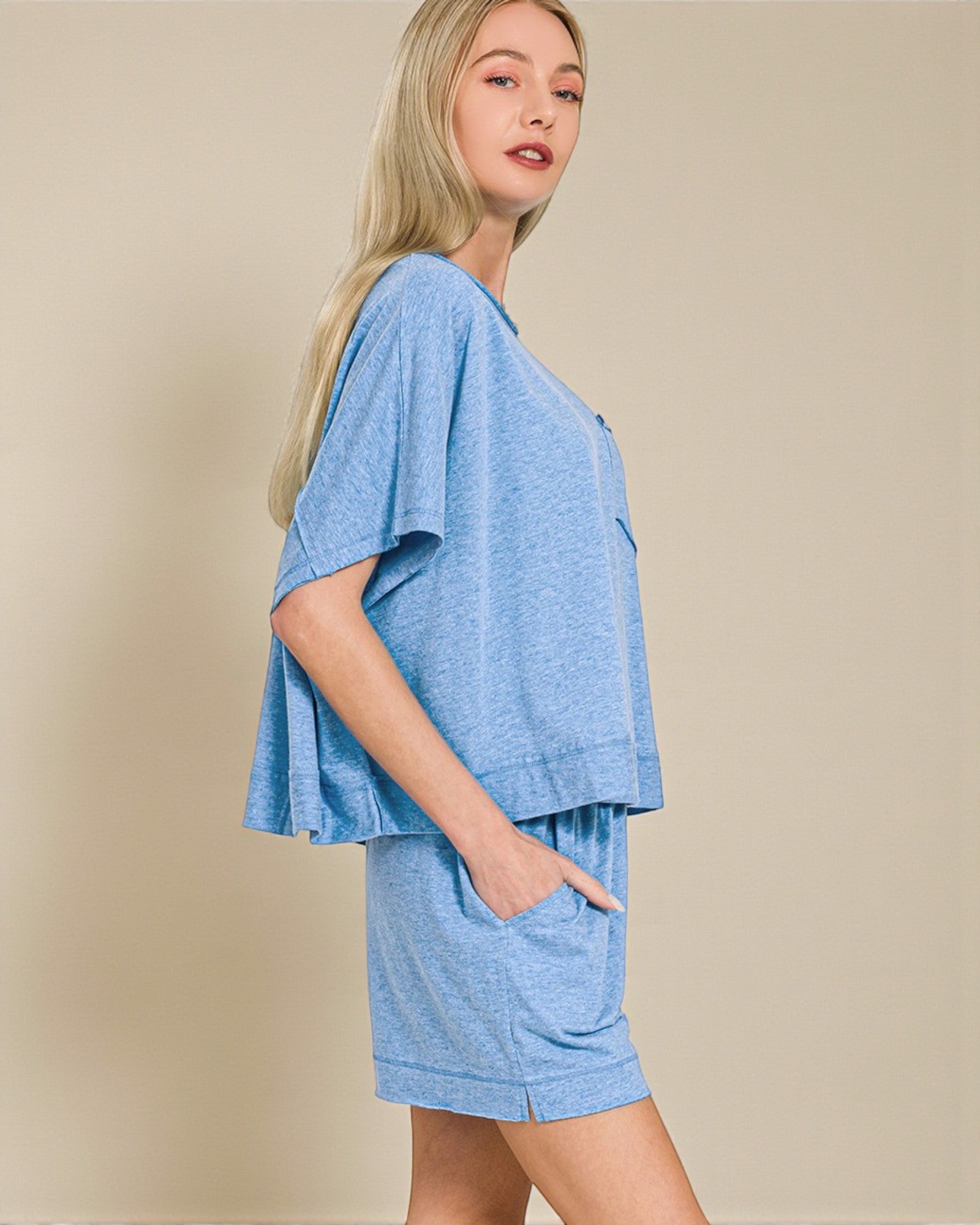 Woman wearing a blue outfit with a plain background