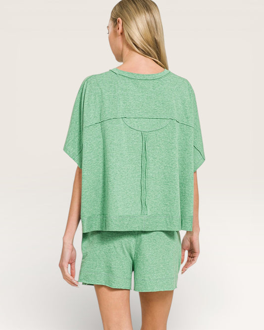 Woman wearing a green outfit on a plain background