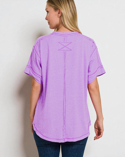 Person wearing a purple t-shirt with a star design on the back against a white background