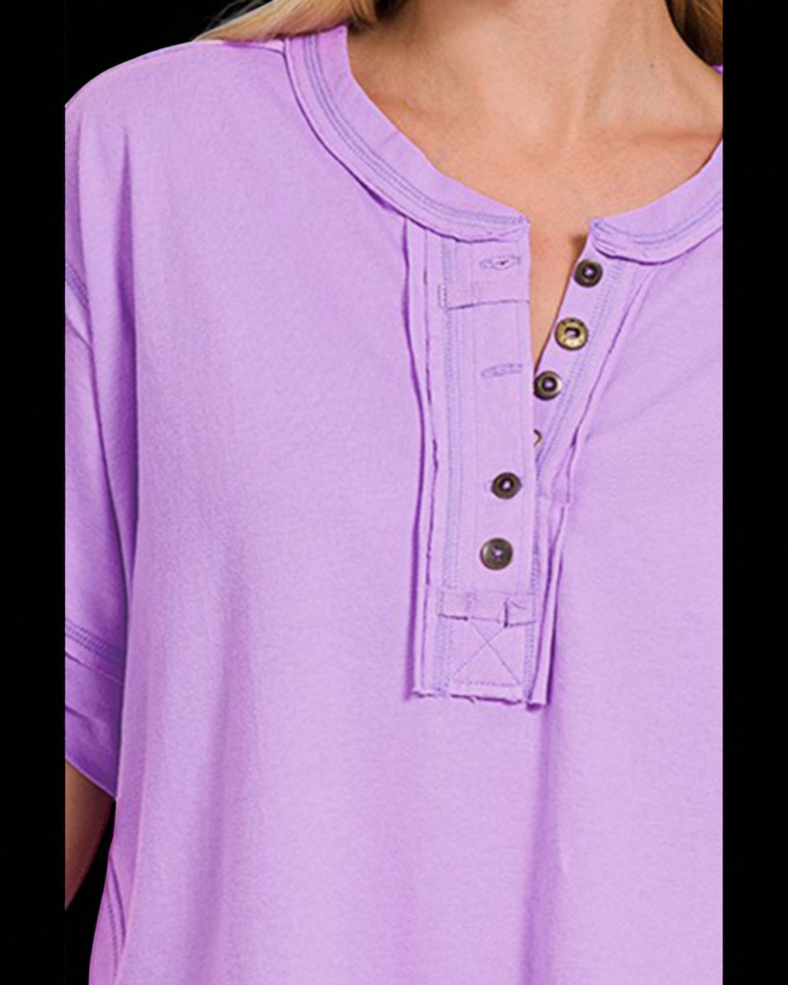Close-up of a purple shirt with button details