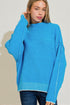 Woman wearing a blue sweater against a plain background