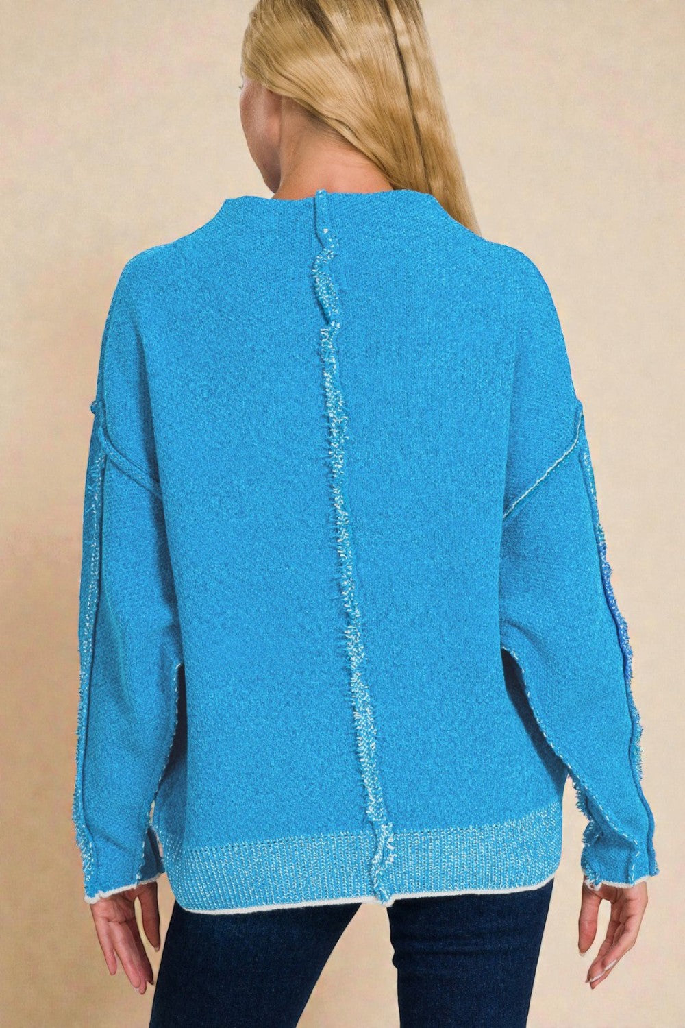 Blue sweater with a zigzag pattern on a beige background