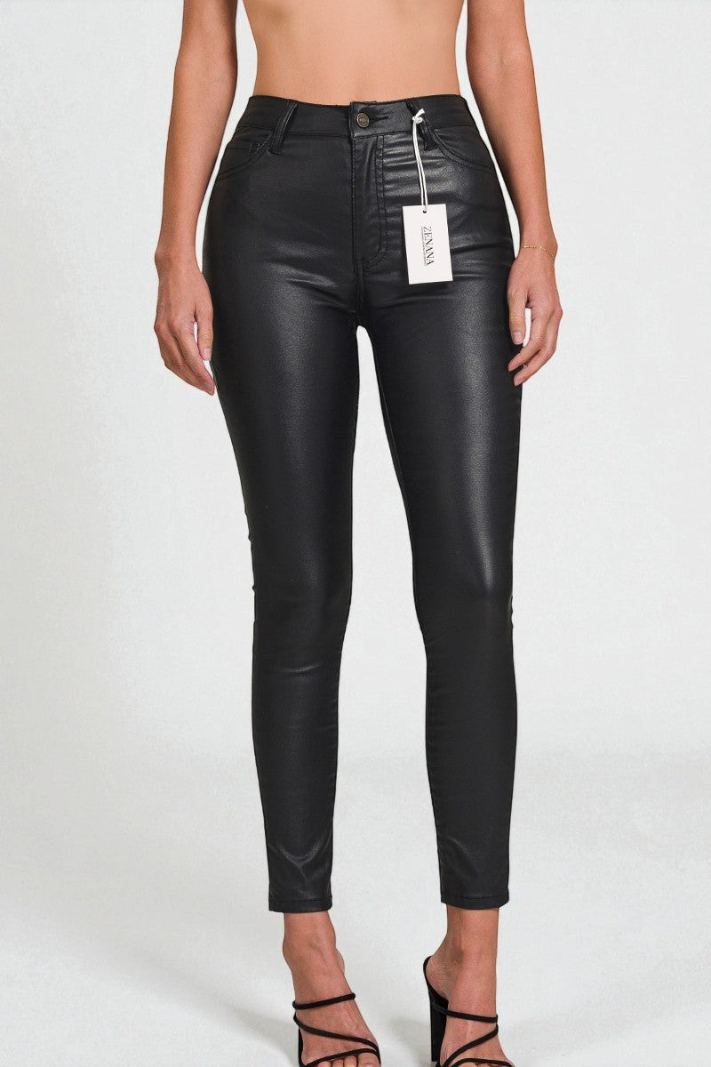 Black leather pants with a tag on a white background