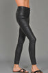 Black leather pants worn by a person on a gray background