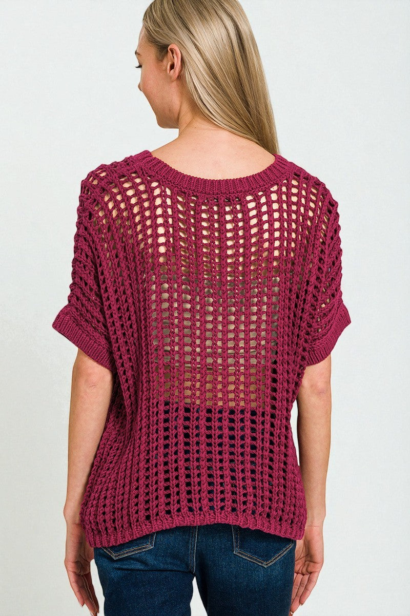 Woman wearing a maroon knitted sweater on a white background