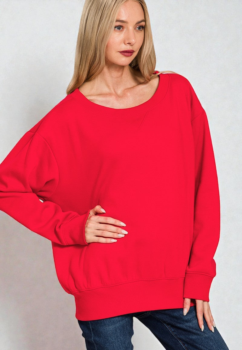 Woman wearing a red sweater against a plain background