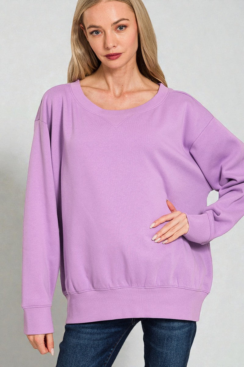 Woman wearing a purple sweatshirt against a plain background