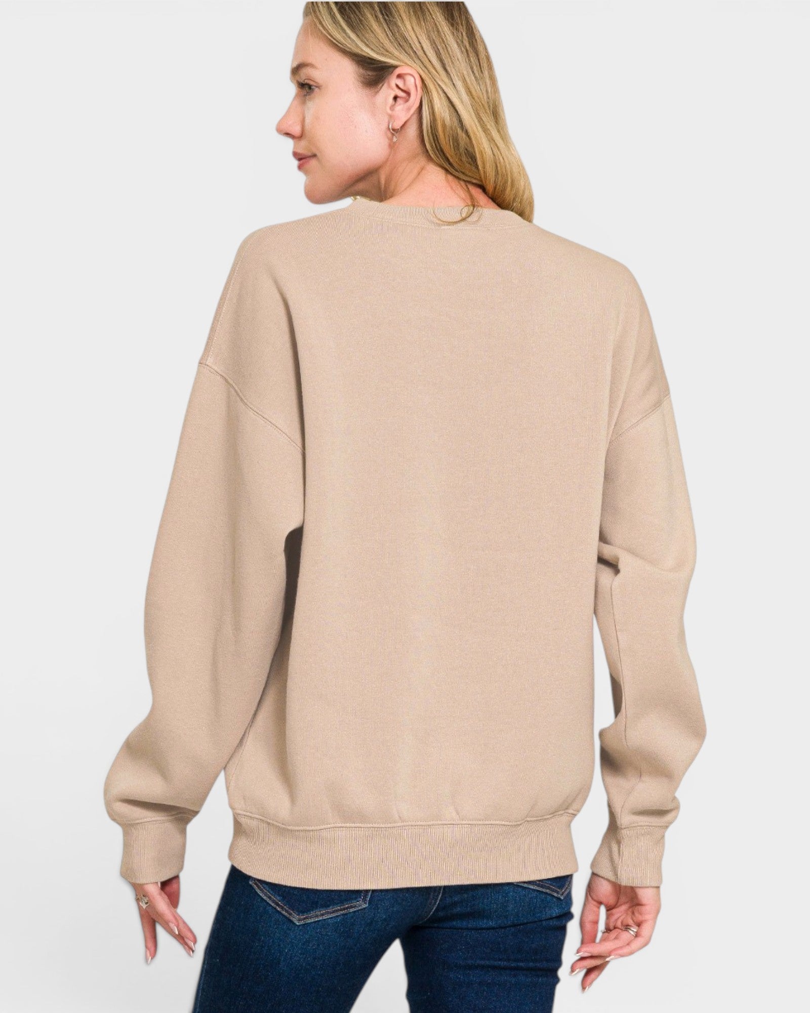 Woman wearing a beige sweatshirt on a white background