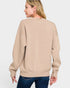 Woman wearing a beige sweatshirt on a white background