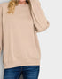 Beige sweatshirt worn by a person on a plain background