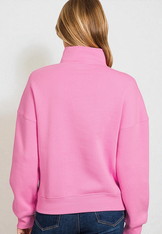 Person wearing a pink jacket on a plain background