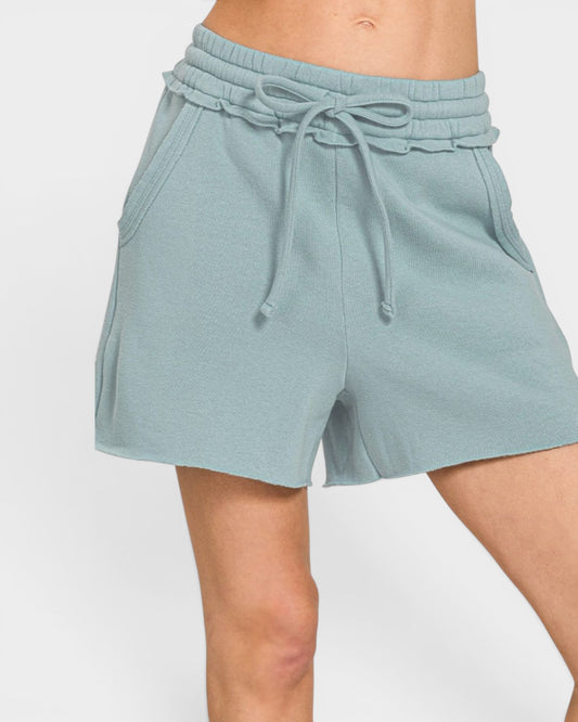 Light blue shorts with a drawstring on a white background