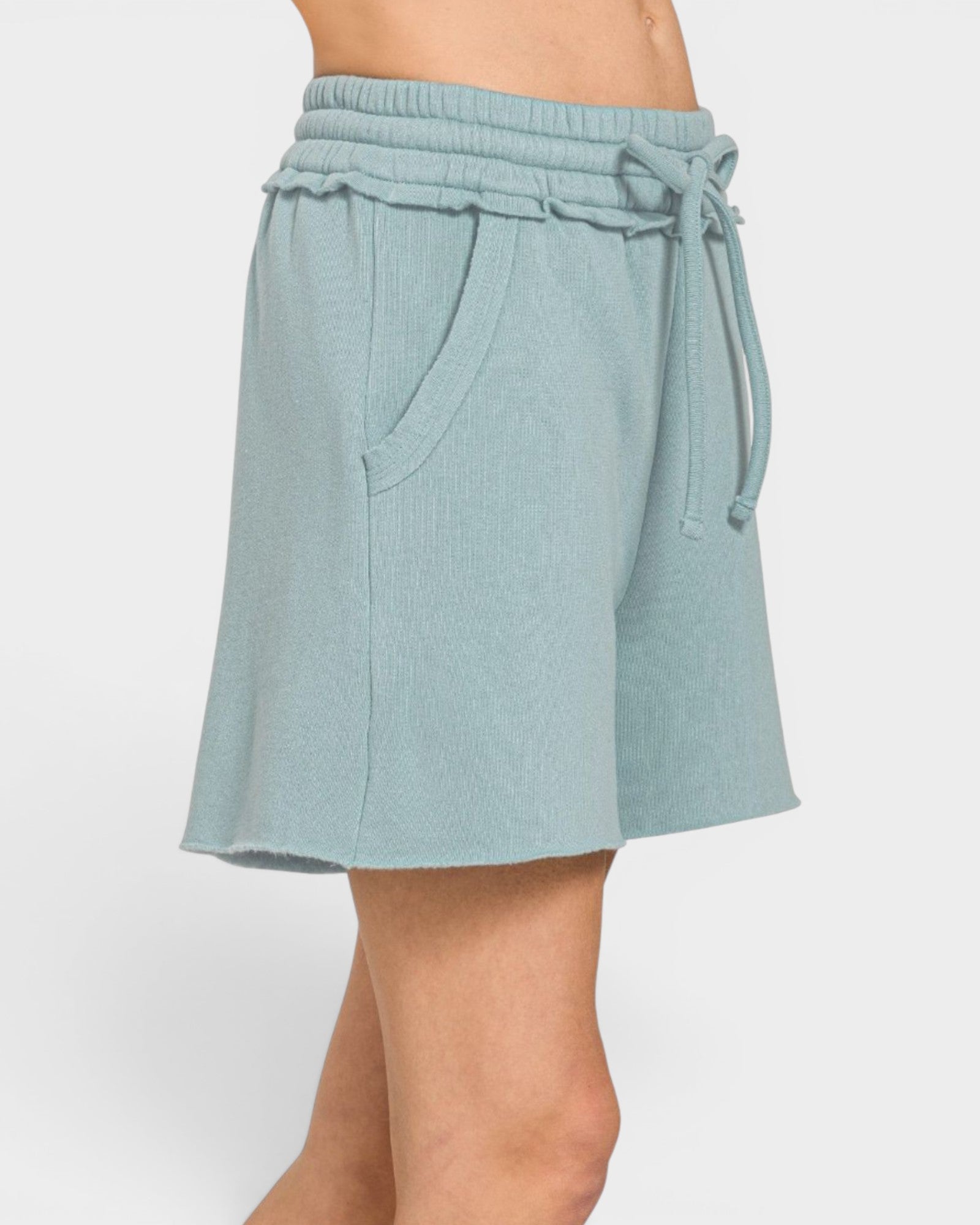 Light blue shorts with a drawstring on a white background