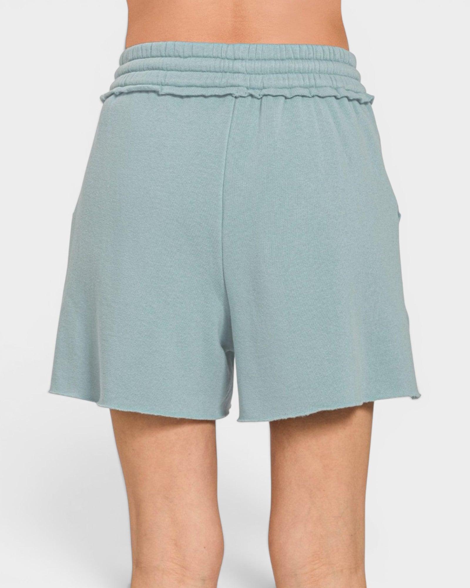 Light blue shorts worn by a person on a white background