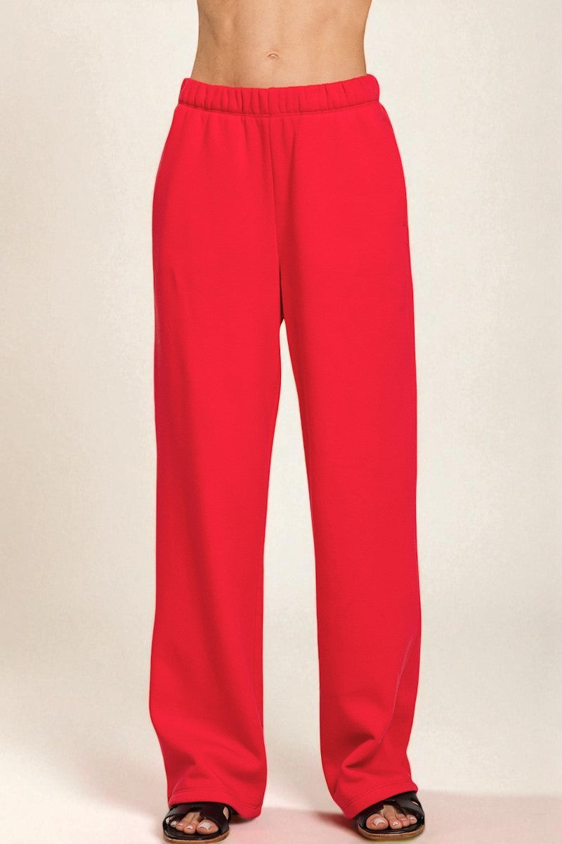 Red sweatpants on a plain background