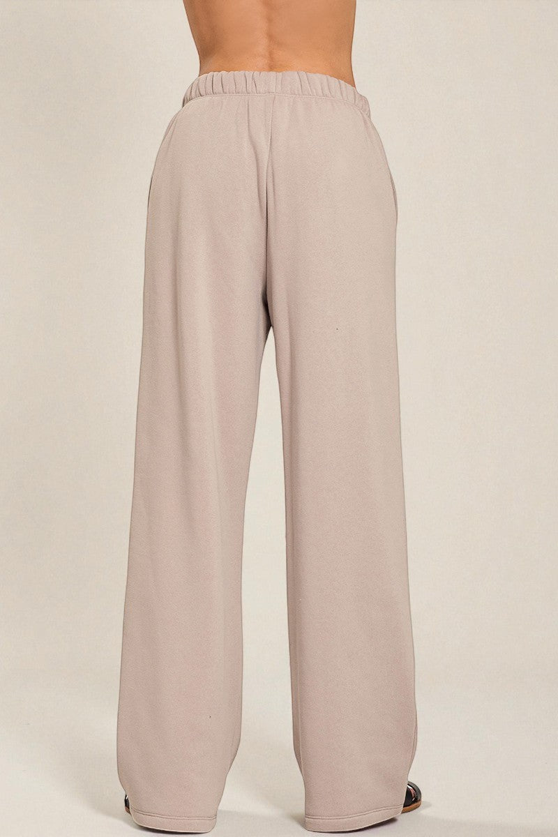 Beige wide-leg pants on a plain background