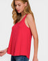 Woman wearing a red sleeveless top on a white background
