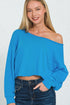 Woman wearing a blue off-shoulder top against a white background