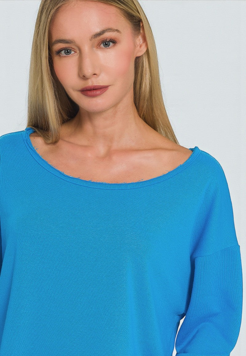 Woman wearing a blue sweater against a plain background