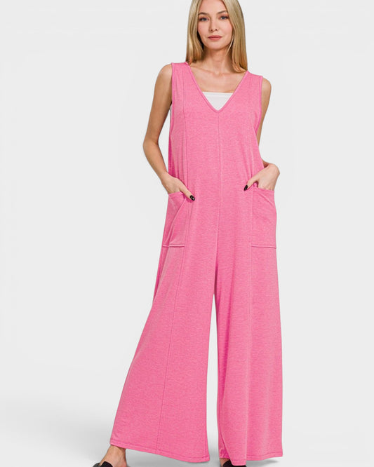 Woman wearing a pink jumpsuit on a white background