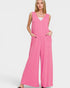 Woman wearing a pink jumpsuit on a white background