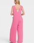 Pink jumpsuit worn by a person on a white background