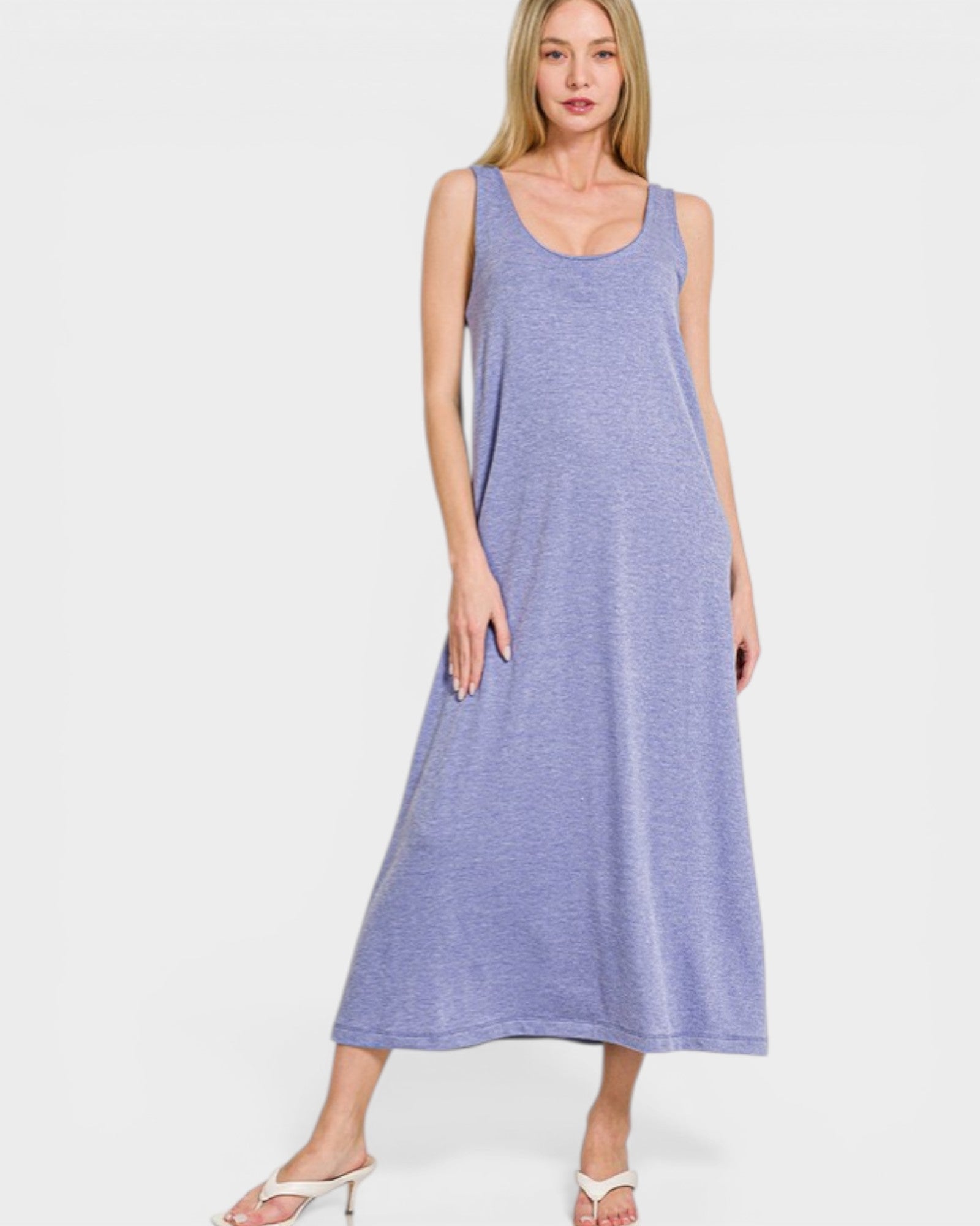 Woman wearing a sleeveless purple dress on a white background