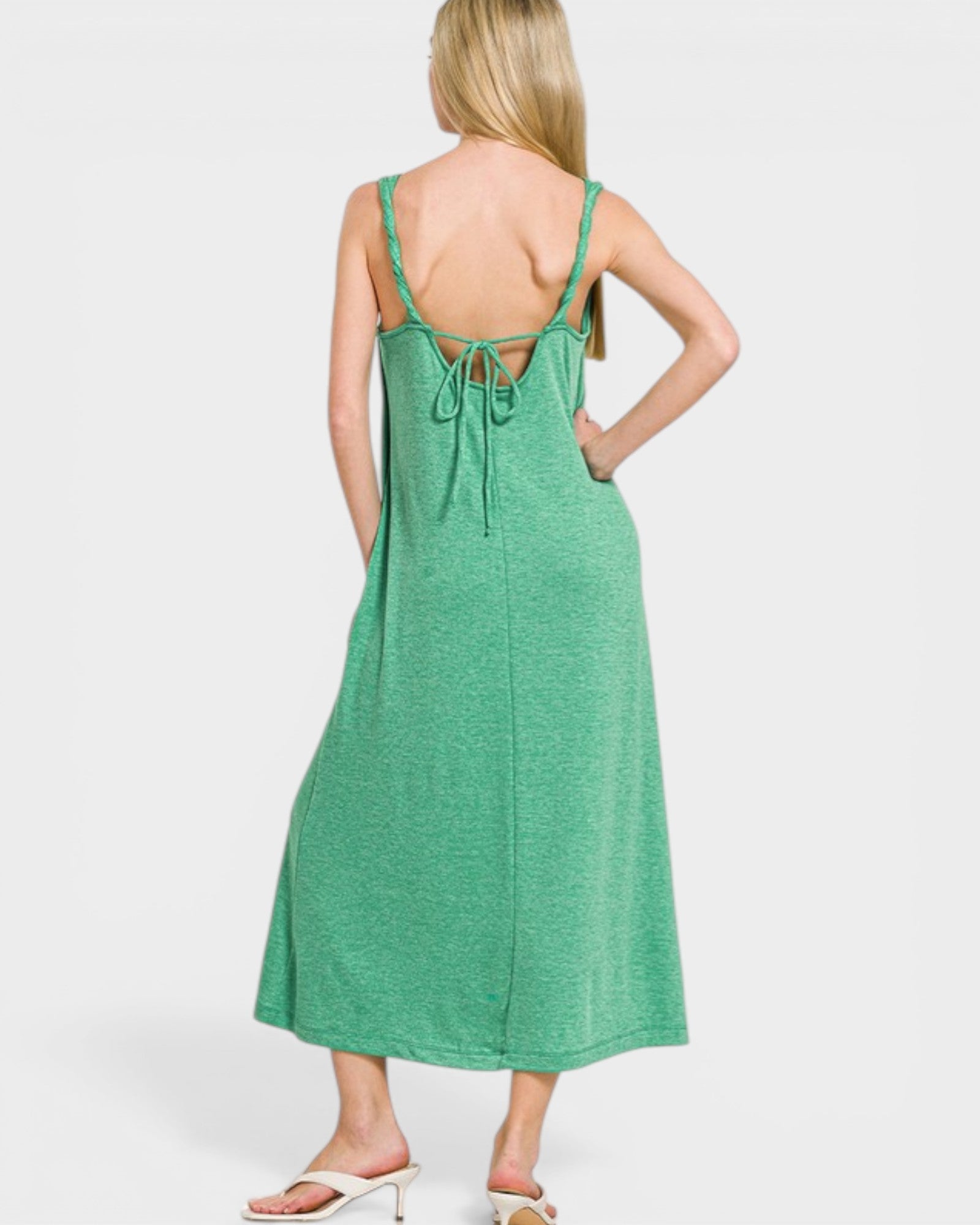 Green slip dress worn by a person on a white background